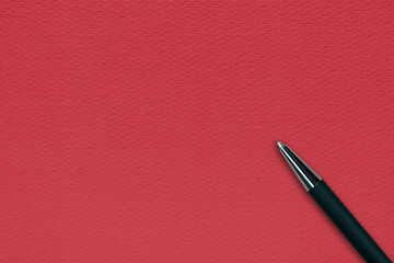 Black ball pen on the red papper background