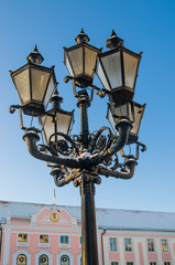 Beautiful street lamp on the background of old buildings