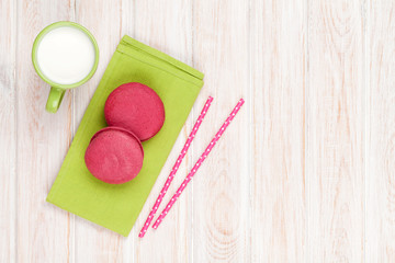 Colorful macarons and cup of milk