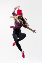 young beautiful dancer jumping on a studio background