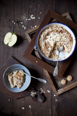 apple crumble with almonds and amaretto biscuits on table