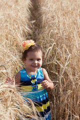 Girl's portrait on a footpath in a wheat field