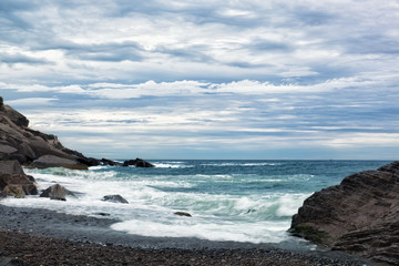 Fototapeta na wymiar Sea waves break about the coast, Laguria, Italy