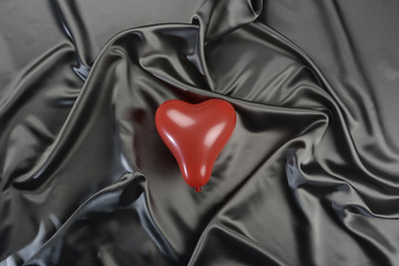 Tela gris y globo rojo en forma de corazón