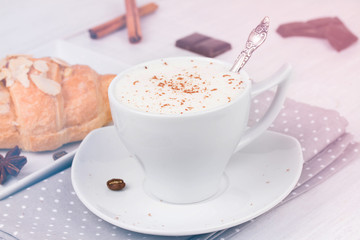Coffee cup and croissant