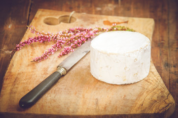 Smelly blue cheese on a wooden rustic table with knife