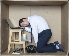 Tired businessman sleeping on the desk