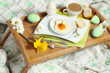 Tray with breakfast on a bed