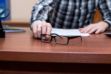 businessman takes glasses off the table