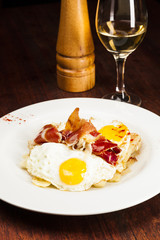 Eggs, potatoes and serrano ham. Huevos rotos.