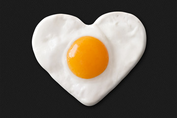 fried egg shaped to heart on teflon pan