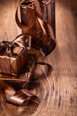 vintage brown gift boxes with bows on old wooden board