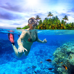 Young women at snorkeling in the tropical water