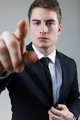Business man with pointing to something or touching a screen.