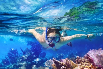 Wall murals Diving Young women at snorkeling in the tropical water