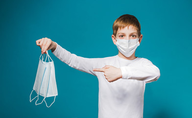 Boy wearing protection mask pointing on masks