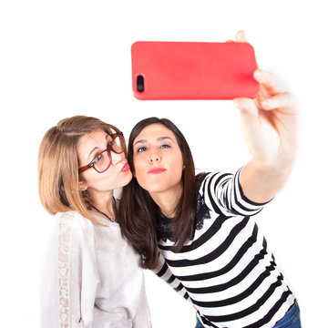 two young women taking selfie with mobile phone