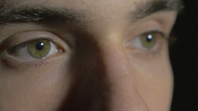 4k UHD - Close-up of a young man eyes opening and blinking