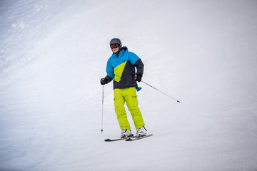 skier riding the downhill on ski resort