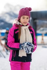 smiling girl posing on top mountain covered by snow