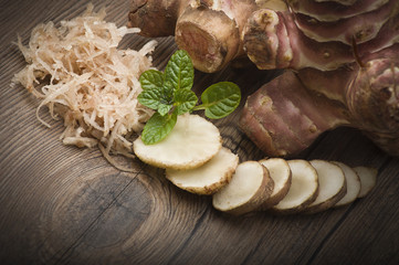Topinambur, cut into slices and julienne on the table