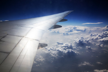 Clouds and sky as seen through window of an aircraft