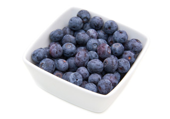 Blueberries on square bowl on a white background