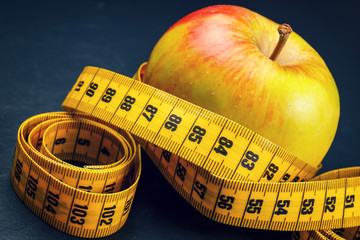 apple with yellow measuring tape