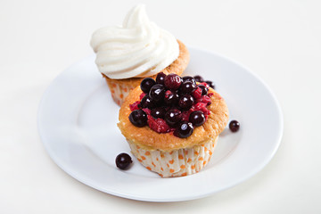 Cupcakes with cream and berries