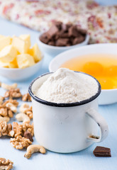 Cup of flour, eggs, butter, nuts and chocolate chunks