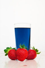 Glass with cold blue Thai tea and strawberries