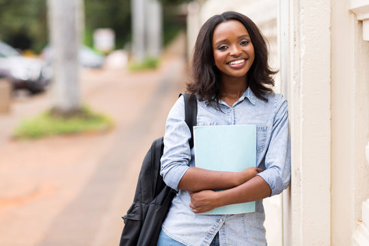 female african american college student holding a book