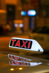Taxi sign from parked taxi in the Milan street at night.