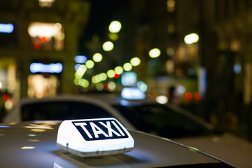 Taxi sign from parked taxi in the Milan street at night.