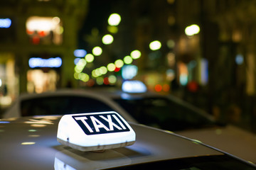 Taxi sign from parked taxi in the Milan street at night.
