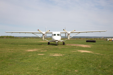 white plane standing in field