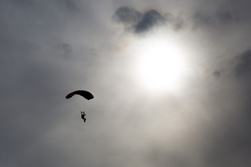 skydiver silhouette against  sun