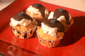 Four capcakes with chocolate and blueberries
