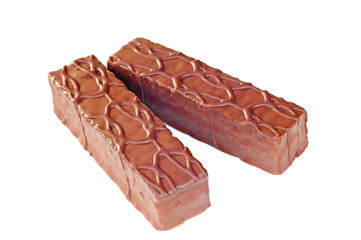 Mini chocolate cakes covered with fudge sauce, white background