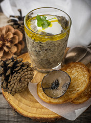 Mushroom pate in a jar over dark background, selective focus,