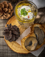 Mushroom pate in a jar over dark background, selective focus,
