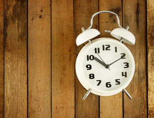 Classic alarm clock on wooden