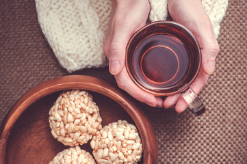 Woman holding cup of black tea