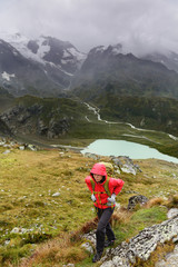 Hiker hiking on trek with backpack in rain