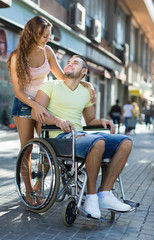 Social worker taking invalid for a walk