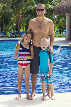Family enjoying the pool at a tropical resort