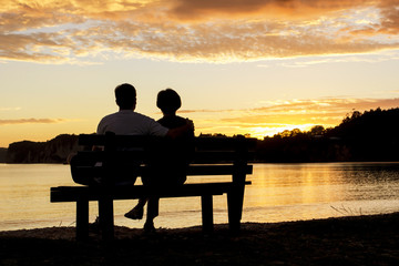 Fototapeta na wymiar Couple watching a beautiful sunset together