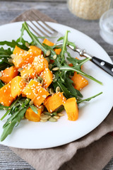 Salad with arugula and pumpkin on a plate