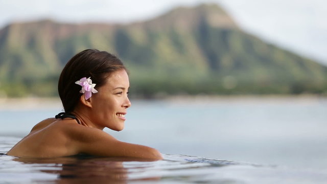 Vacation woman swimming at infinity pool on Hawaii