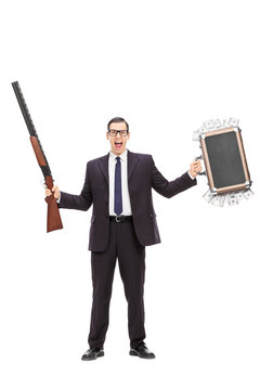 Businessman holding rifle and a bag full of money